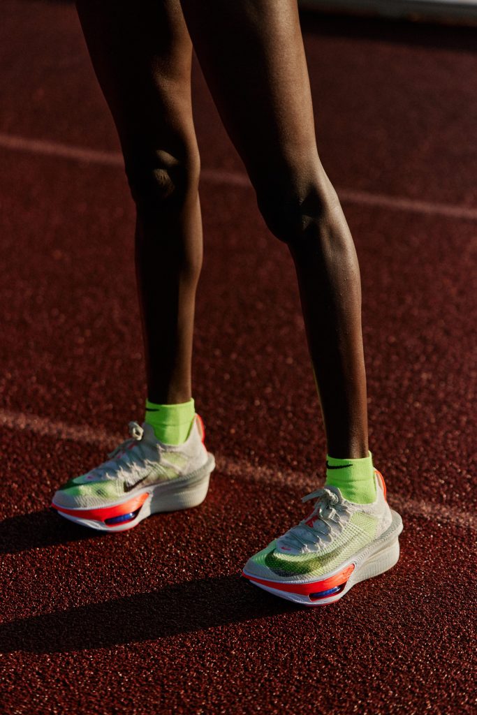 les jambes d'une coureuse avec des chaussures de running blanches